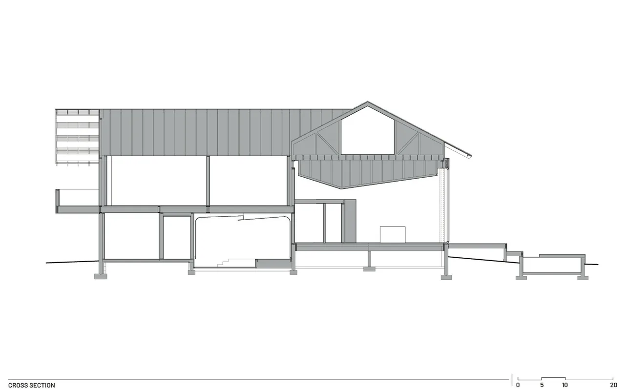Cross section showing the interior layout and structure of the Diagonal House with a timber gable roof overhang.