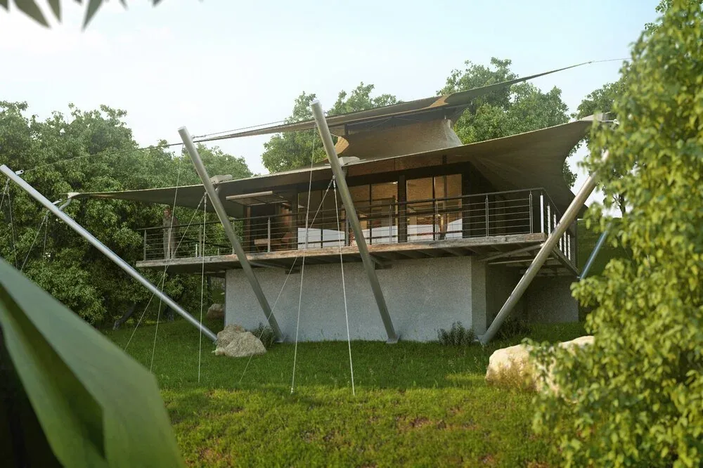 Sail House features a raised concrete base with a wooden deck and tensioned shade sails supported by angled metal poles.