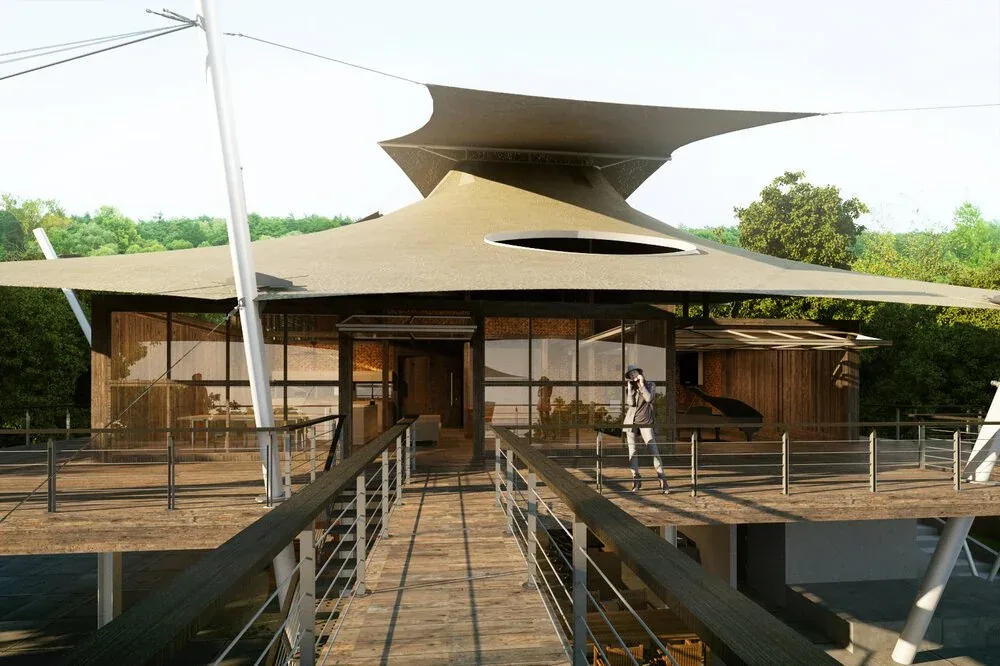 The SAIL HOUSE features a large tensioned shade sail roof supported by metal cables, with a wooden deck and railing.