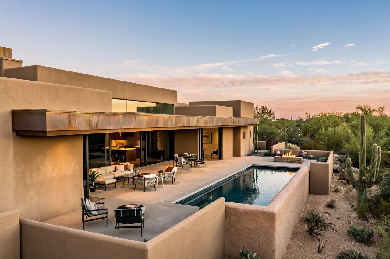 Modern-style outdoor living space at Shea-Naito Residence features a pool, fire pit, and seating area amid desert landscaping.