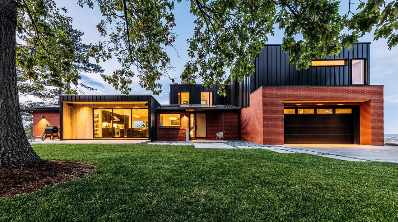 The Foothill project features a modern design with black metal and brick exterior, large windows, and an attached garage.