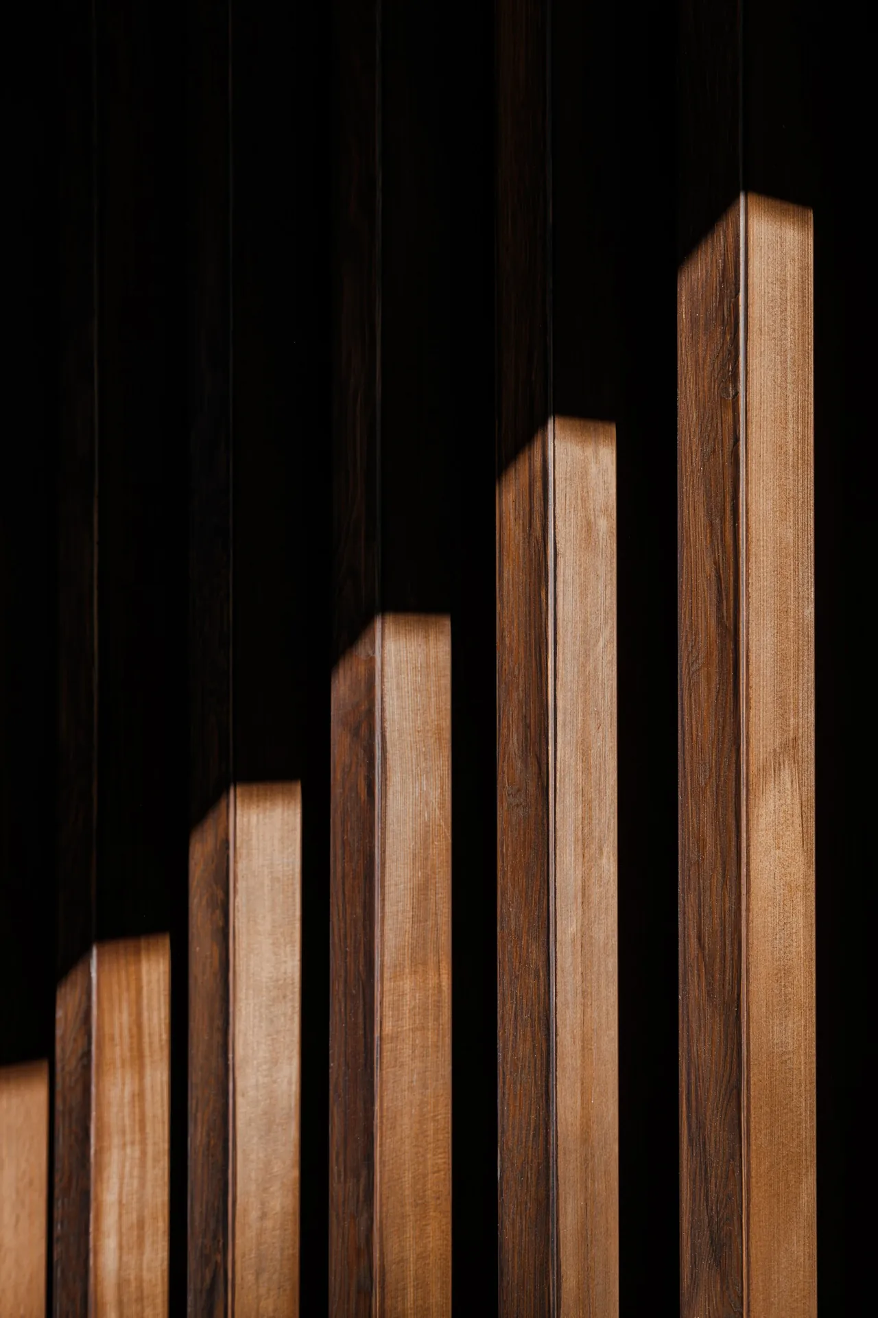 Vertical wood slats showing wood grain with shadows highlighting depth