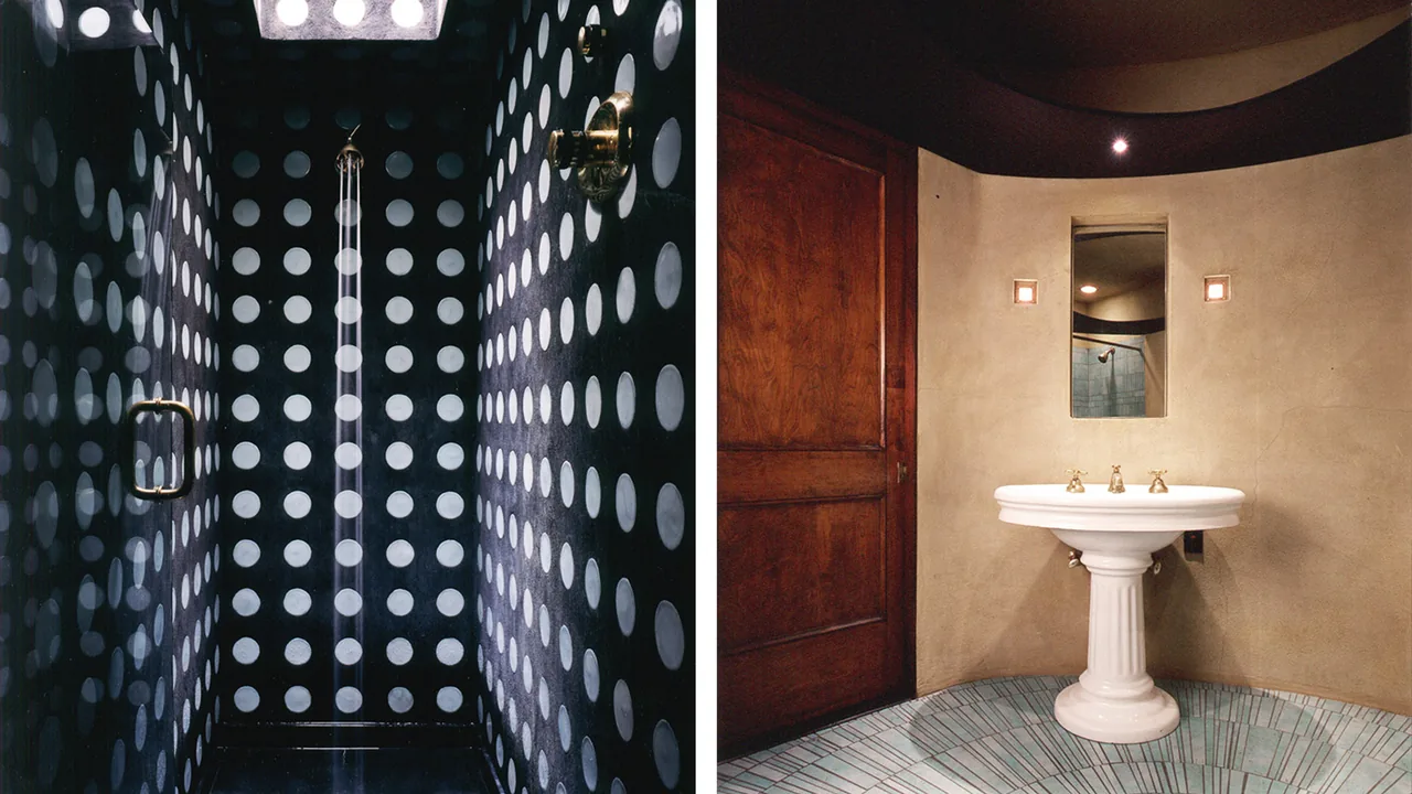 This bathroom features circular patterned black and white tiles and a pedestal sink against textured plaster walls.