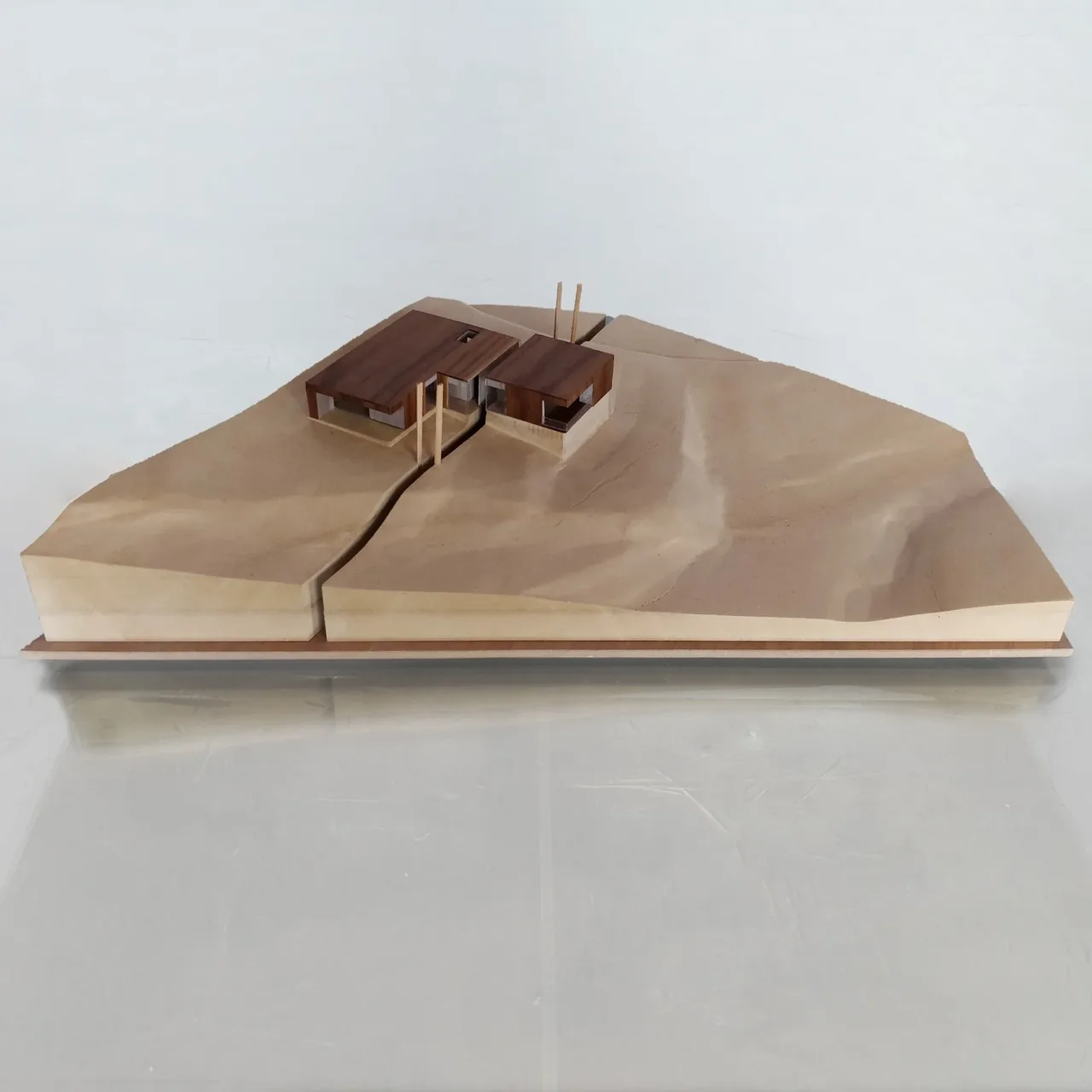 Model of Emigration Creek Residence by Sparano Mooney Architecture on a terrain base with two wood-topped structures.