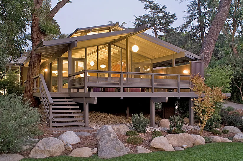 Canon Residence features a raised deck with exposed beams and illuminated interiors.