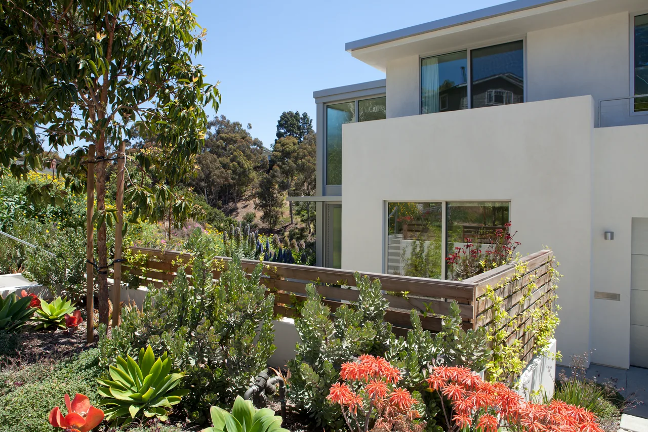 Clark Street Private Residences feature natural landscaping and wood fencing on a hillside site in San Diego.