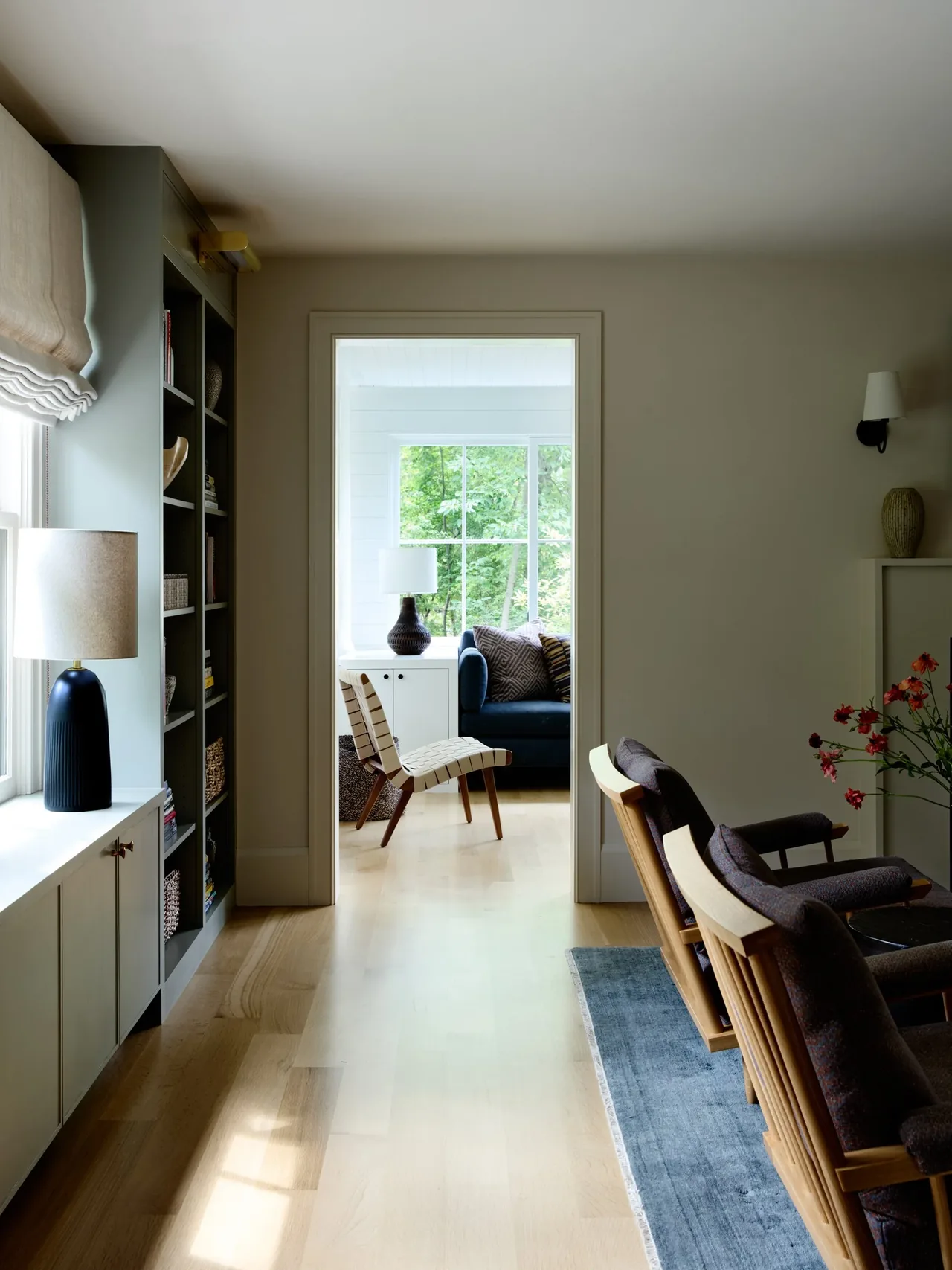Interior view showing a hallway leading to a living room with patterned cushions and wooden furniture at Valentine House.