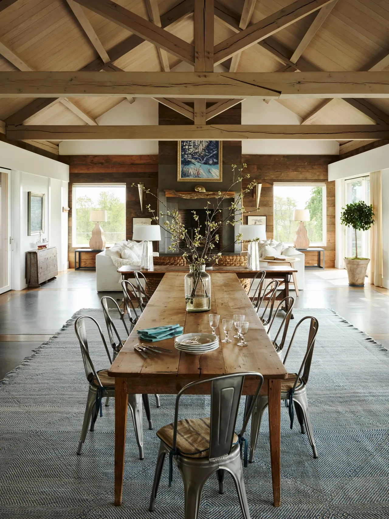 The Westport House features an open dining and living area with exposed wood beam ceiling and natural wood elements.