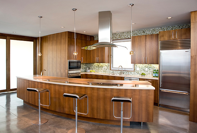 Rogers-Sturz Residence kitchen with curved island and pendant lighting by Michael Lee Architects in Los Angeles.