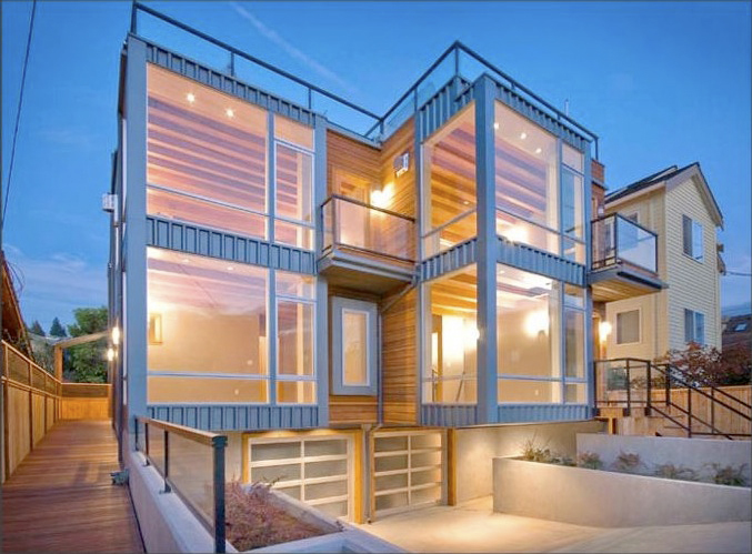 Alki Townhomes feature wood siding with large glass window walls and black metal framing and railings.