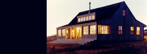 Exterior of Pile Point house by Hoedemaker Pfeiffer featuring a coastal setting and wood chimney pipe.