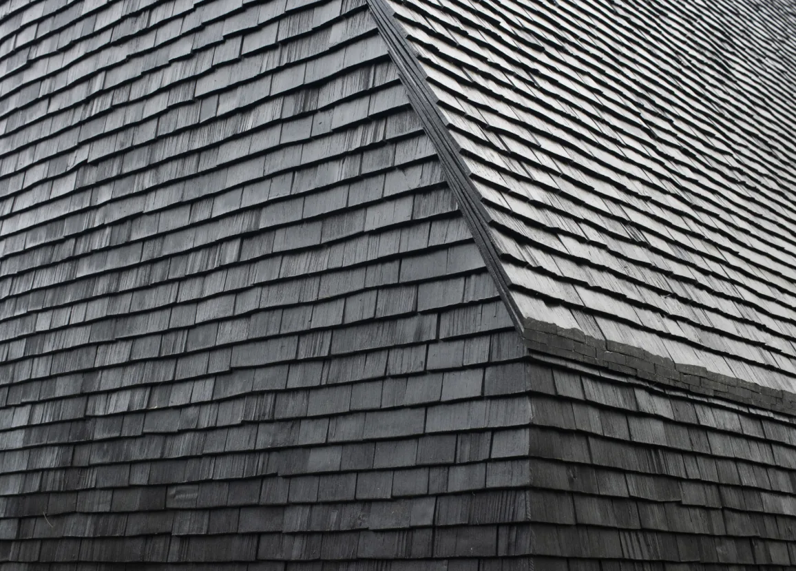 Detail of the dark gray wooden shingle roof of the Hudson Valley House II.
