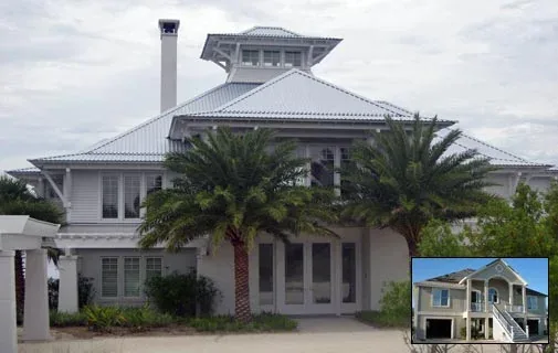 Front exterior view of a large two-story house with a metal hip roof and palm trees in front.